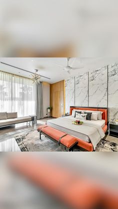 a large bedroom with marble walls and flooring