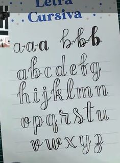 there is a handwritten alphabet written in cursive writing on a piece of paper