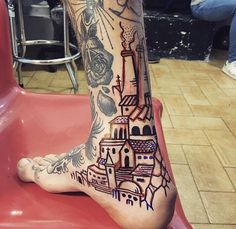 a person's foot with tattoos on it