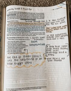 an open book with writing on it sitting on top of a carpeted floor next to a wall