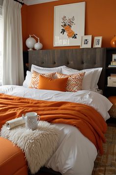 a bedroom with orange walls and white bedding