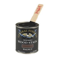 a can of wood stain with a wooden spoon in it