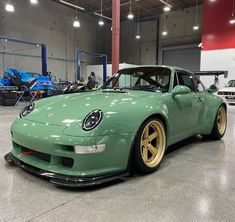 a green sports car parked in a garage