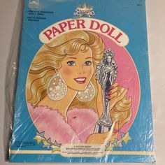 the front cover of barbie paper doll magazine, with an image of a woman holding a statue