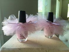 two pink nail polish bottles with tulle on them