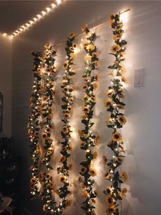 the sunflowers are hanging from the wall with fairy lights on them and there is no image to describe