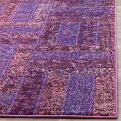 a purple and pink rug on the floor