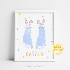 an easter card with two rabbits in blue and pink, on top of a white shelf