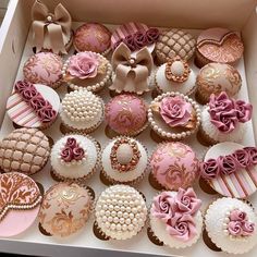 a box filled with lots of decorated cupcakes