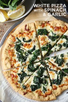 a pizza with spinach and cheese cut into slices