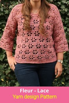 a woman standing in front of a bush wearing a pink crochet sweater