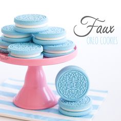 a pink cake stand with cookies on it and the words faux oreo cookies