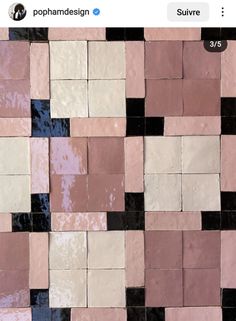 a tile wall with black and white squares on it's sides, as well as pink and brown tiles