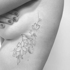 a black and white photo of a woman's stomach with flowers on it,