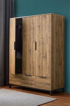 a wooden armoire sitting on top of a hard wood floor next to a window