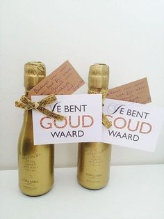 two wine bottles wrapped in gold ribbon and labeled with we bent, good, wardd