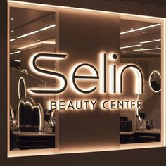 the front window of a beauty center that is lit up