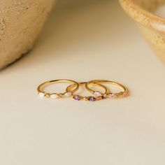 Your ultimate stacking ring has arrived! Our Triple Marquise Birthstone Ring allows you to customize to the stone you want. With delicate CZ Diamond gemstones in between each marquise birthstone, this ring shines with even more sparkle. Material: High Quality Solid 925 Sterling Silver Finish: Sterling Silver ∙ 18K Gold ∙ Rose Gold Featuring a ~1mm Dainty Ring Band with three ~3.5 x 2mm Marquise Gemstones and ~1mm Round CZ Diamond Stones Part of our Birthstone Collection The OPAL Marquise Ring in Three Stone Birthstone Ring, Stackable Marquise 14k Gold Rings, Marquise Gemstone Stackable Promise Rings, Marquise Gemstone Stackable Rings For Anniversary, Dainty Marquise Gold Stackable Rings, Anniversary Marquise Stackable Gemstone Rings, Gold Marquise Stackable Rings, Dainty Style, Dainty Stackable Marquise Cut Rings, Gold Marquise Stackable Rings