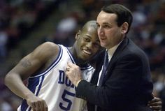 two basketball players hugging each other on the court