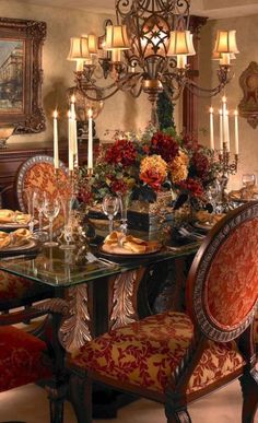 a fancy dining room with red chairs and chandelier