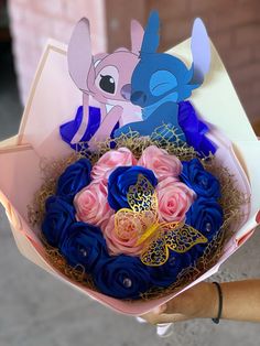 a person holding a bouquet of flowers with stitching on it