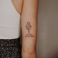 a woman's arm with a tattoo saying no rain, no flowers on it