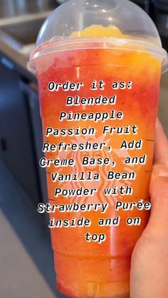 a person holding up a cup with orange juice in it that says order it as a blended pineapple, passion fruit, refresher, and creme base