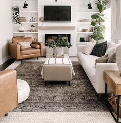 a living room filled with furniture and a flat screen tv mounted on the wall above a fireplace