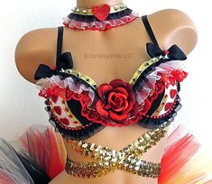 a close up of a mannequin wearing a red and black top with flowers on it