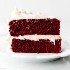 a slice of red velvet cake with white frosting