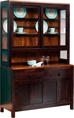 a wooden cabinet with glass doors and plates on it