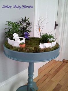 an outdoor fairy garden on a table with chairs and plants in it is featured for the pinterest kids fairy garden