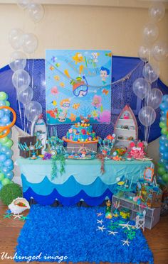 an under the sea themed birthday party with balloons, decorations and streamers on the floor