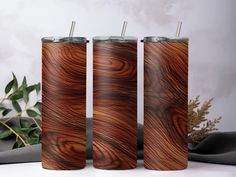 three wooden tumblers sitting next to each other