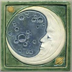 a ceramic tile with the face of a woman's head and bubbles on it