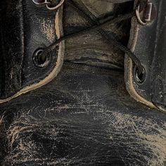 an old pair of black leather boots with laces