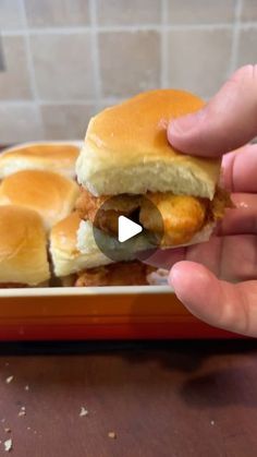 someone is taking a slider out of the pan