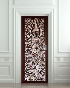 the door is decorated with intricate designs and wood paneling, along with white walls