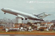 an airplane taking off from the runway in front of a cityscape with skyscrapers