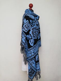 "Beautiful Mexican rebozo grecado, extra long, for cold season, with an original flower design. Our shawls are made with threads that are exquisitely combined with different techniques to create unique designs of high quality and soft textures that will make your shawl a unique piece Mexican textile art has centuries of history and creativity throughout the country. Mexico is recognized as one of the leading countries with a beautiful artistic production in the textile world, miraculous hands of Traditional Blue Pashmina Scarves, Traditional Winter Shawl For Gift, Traditional Shawl Scarves As Gift, Traditional Blue Scarf As Gift, Traditional Blue Handloom Shawl, Blue Traditional Pashmina Shawl, Blue Pashmina Shawl With Traditional Drape, Blue Shawl With Traditional Patterns And Drape, Blue Shawl With Traditional Patterns