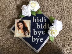 a graduation cap decorated with flowers and an image of a woman