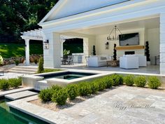 an outdoor living area with pool, patio and dining room in the back yard is shown