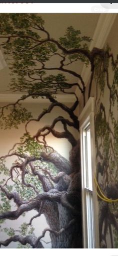 a tree painted on the wall next to a window