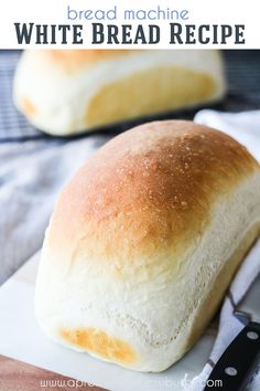 two loaves of bread sitting on top of a cutting board next to a knife