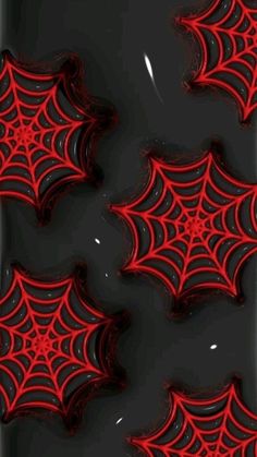 some red and black spider webs on a black surface