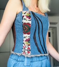 Welcome to my shop! Introducing a unique corset top made from recycled denim, combined with leather and linen. This piece is perfect for hot summers, designed to accentuate your figure. The corset top features an enchanting design with back lacing, allowing for waist adjustment. This adds flexibility and ensures a perfect fit. A side zipper closure makes it easy to put on and take off. Every detail of the corset top is crafted with meticulous attention and skill. It is adorned with appliques and Spring Sleeveless Patchwork Crop Top, Denim Blue Patchwork Tops For Summer, Bohemian Sleeveless Corset For Summer, Summer Sleeveless Patchwork Denim Vest, Sleeveless Patchwork Denim Vest For Summer, Fitted Patchwork Crop Top For Spring, Summer Sleeveless Denim Vest With Patchwork, Denim Blue Summer Corset, Fitted Cotton Patchwork Crop Top