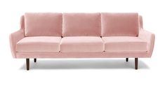 a pink couch sitting on top of a white floor