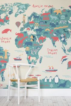 a white chair sitting in front of a wall with an animal map on it's side