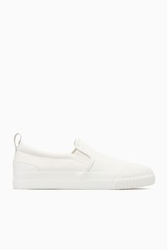 These slip-on trainers are an easy option for summer dressing – they'll go with all your casual outfits but will work equally well to pare back tailoring, too. Crafted from cotton-canvas with leather detailing, they come in versatile white and have chunky rubber soles and elasticated inserts for comfort. The leather pull tab at the back makes them easy to slip on and off. Leather binding and panellingRecycled cotton is made by converting both pre- and post-consumer fabric into fibres that are th Belted Cape, Summer Dressing, Leather Binding, Mens Cardigan Sweater, Leather Detailing, Slip On Trainers, Accessories Bags Shoes, Denim Sweater, Woman Silhouette