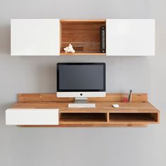 a computer monitor sitting on top of a wooden desk